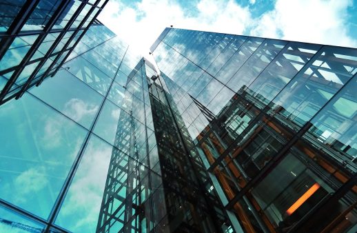 Worm's eye perspective of a commercial building covered with glass